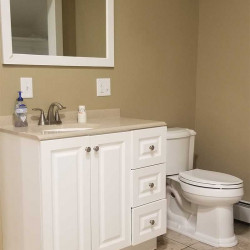 White bathroom vanity and toilet