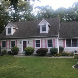 Front view of Cape style house with siding